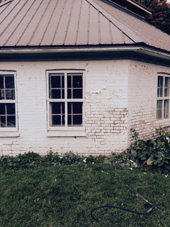 Exterior painted brick before cleaning